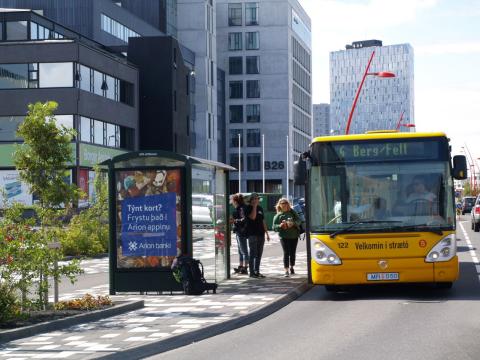 A public bus driving down Borgartún