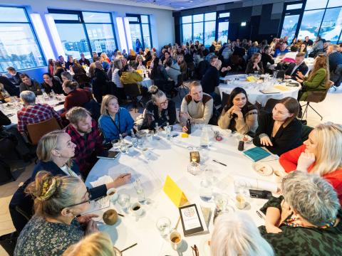 From Safety Week 2026. Security guards and safety representatives attended a conference where workplace safety experts delivered various presentations. Multiple people sit at a round table.