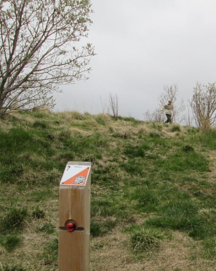 An orienteering participant approaches one of the stations.