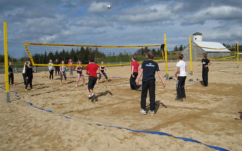 People playing beach volleyball at Gufunesbær.