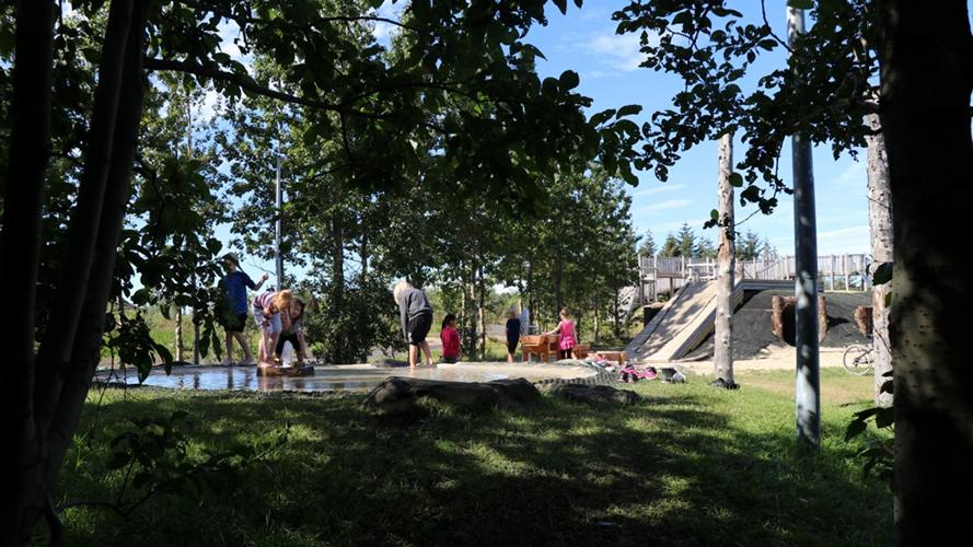 Children splash around in the water feature at The Recreational Park at Gufunes.
