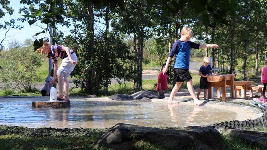 Children splash around in the water feature at The Recreational Park at Gufunes.